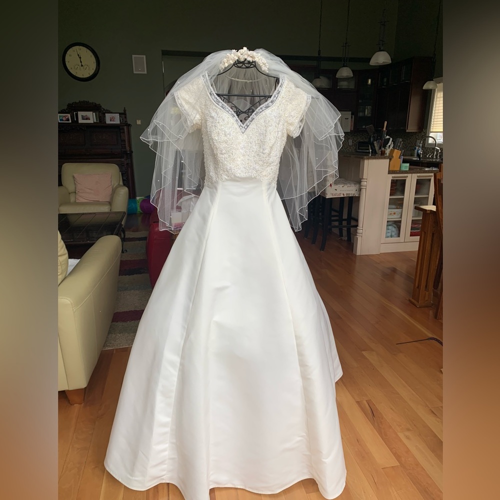 Off white bridal gown, never altered with matching tiara and matching veil.
